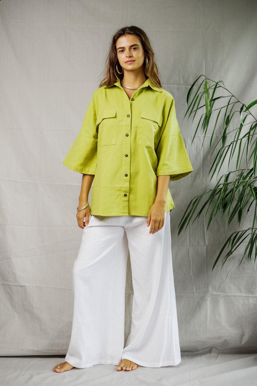 Light pistachio linen button-up shirt with wide 3/4 sleeves and front chest pockets.