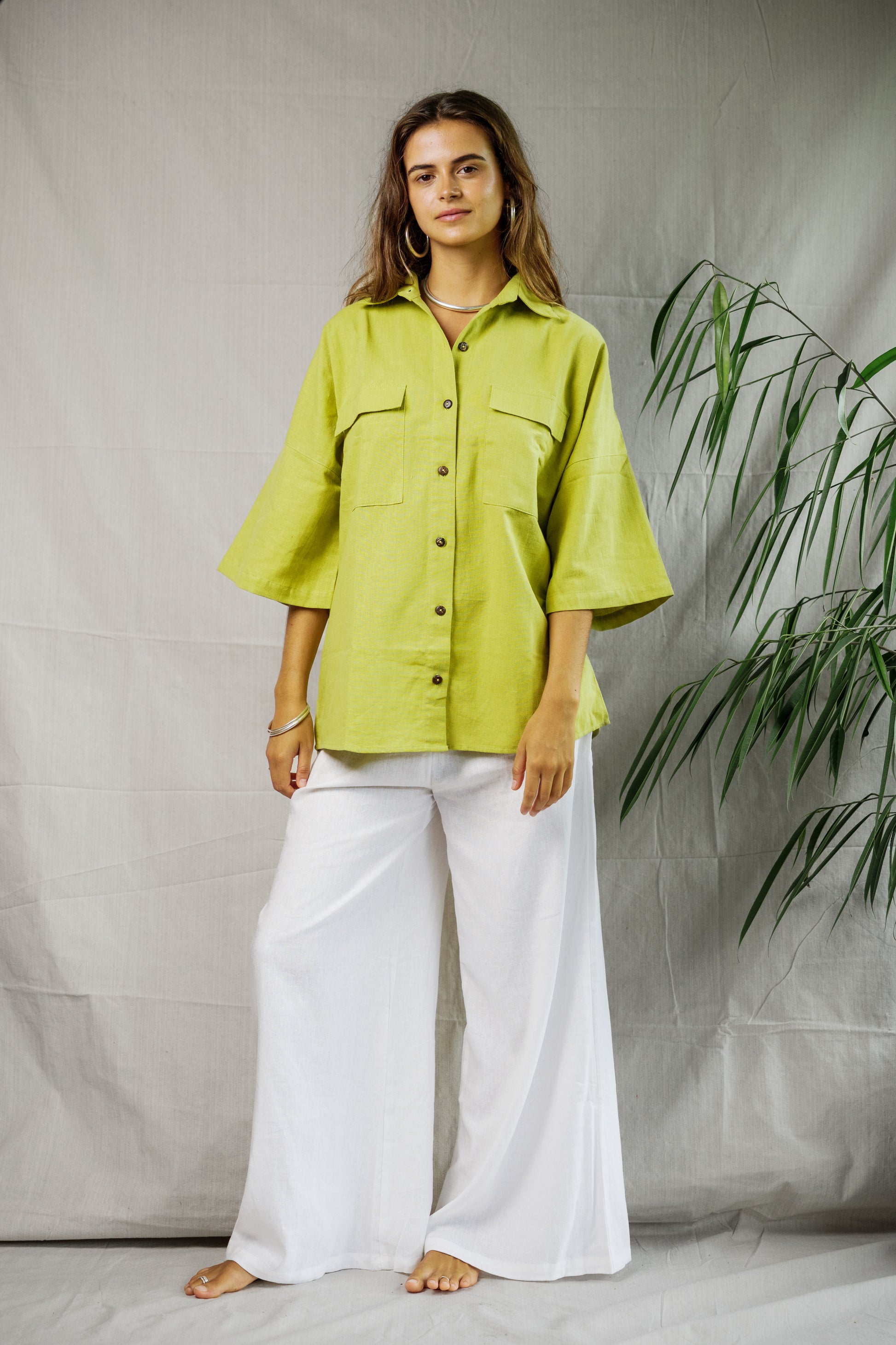 Light pistachio linen button-up shirt with wide 3/4 sleeves and front chest pockets.